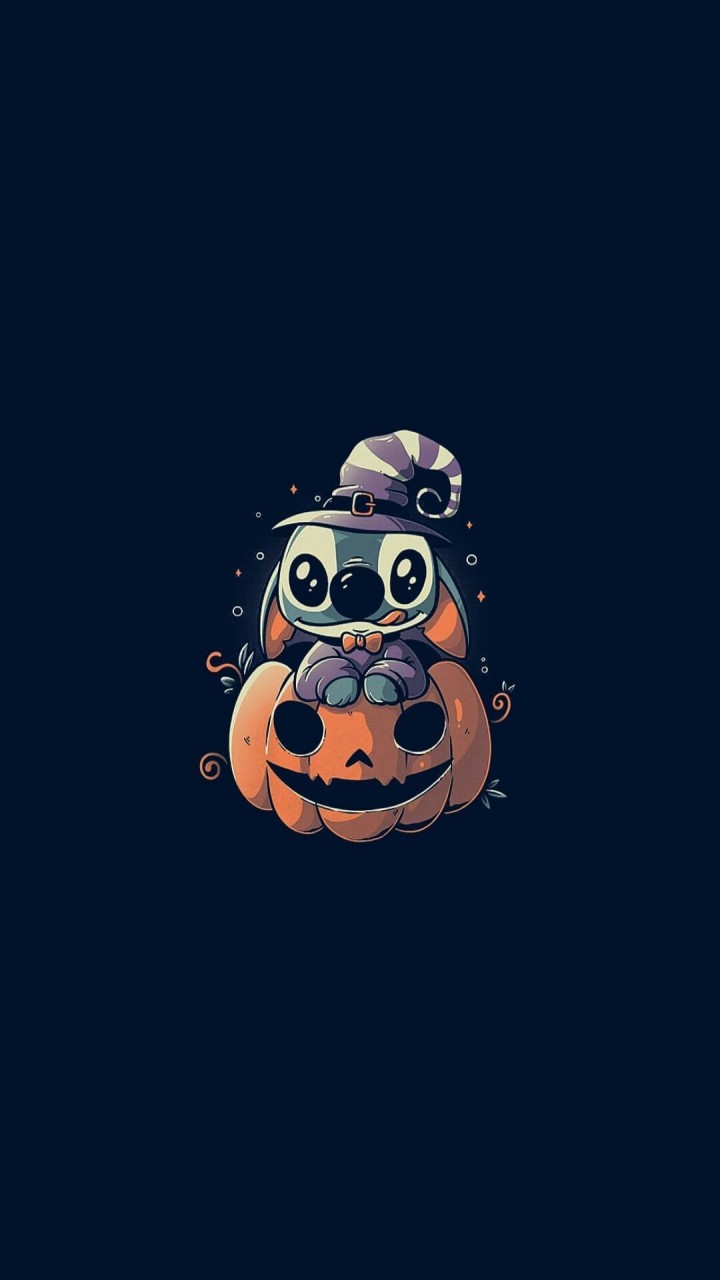 Stitch sits on a halloween pumpkin wearing a hat