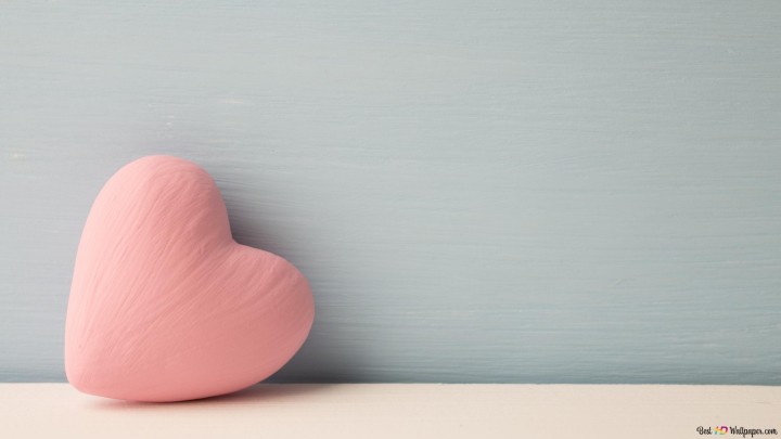 Teddy bear holding a heart with I love you written