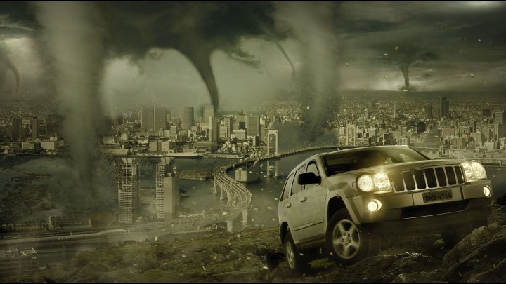 Tornado under dark storm clouds over a field