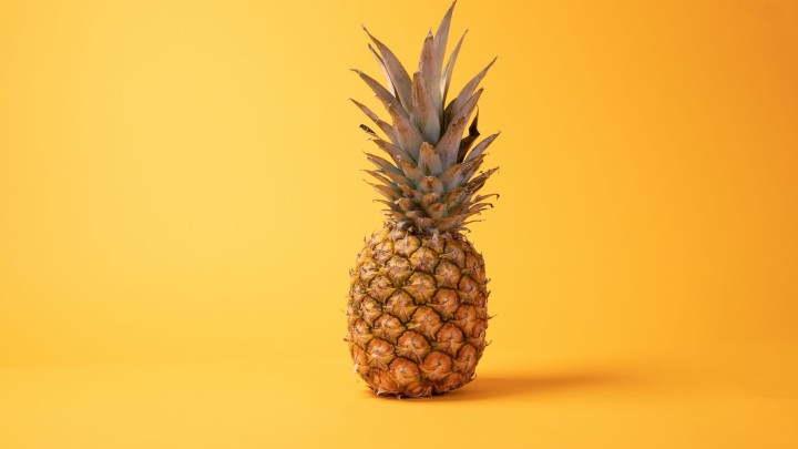 Whole pineapple on a wooden table