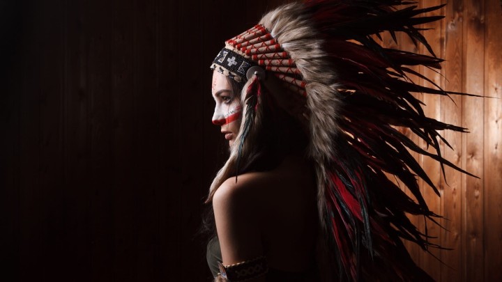 Woman in Native American headdress and face paint