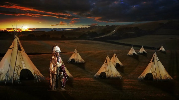Woman in Native American headdress tribal paint forest