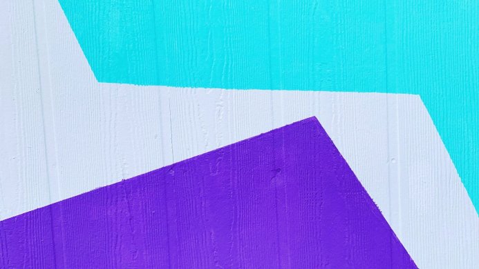 Abstract geometric shapes in purple, turquoise and white on a textured surface