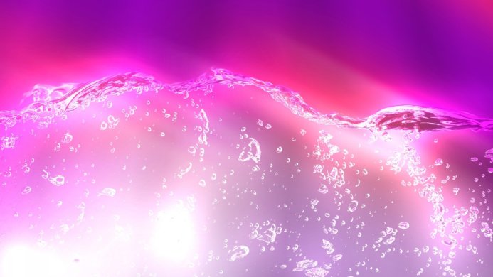 Abstract image of splashing water with bubbles and purple and pink background