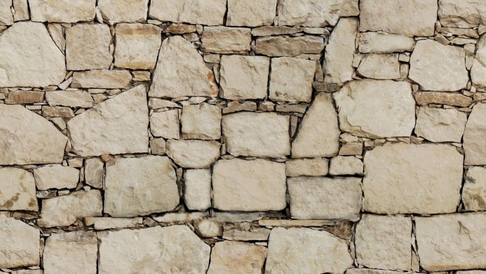 Close-up of a beige stone wall with varying sizes and shapes of stones
