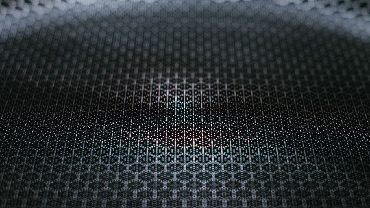 Close-up dark abstract pattern of dots and hexagons