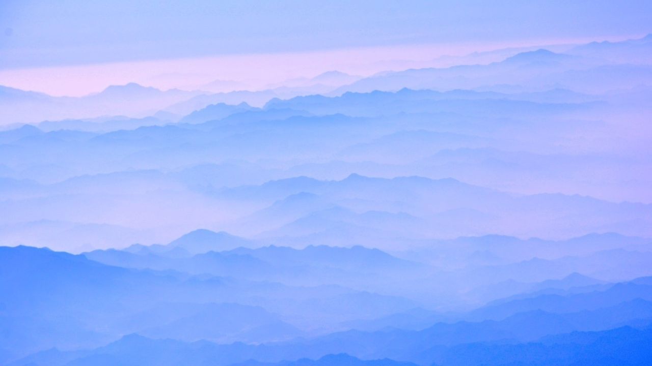 Blue misty mountain range landscape
