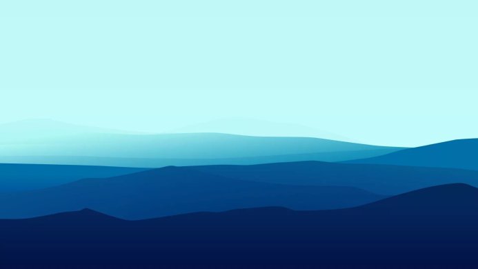 Blue mountain range landscape with layered hills and a light blue sky