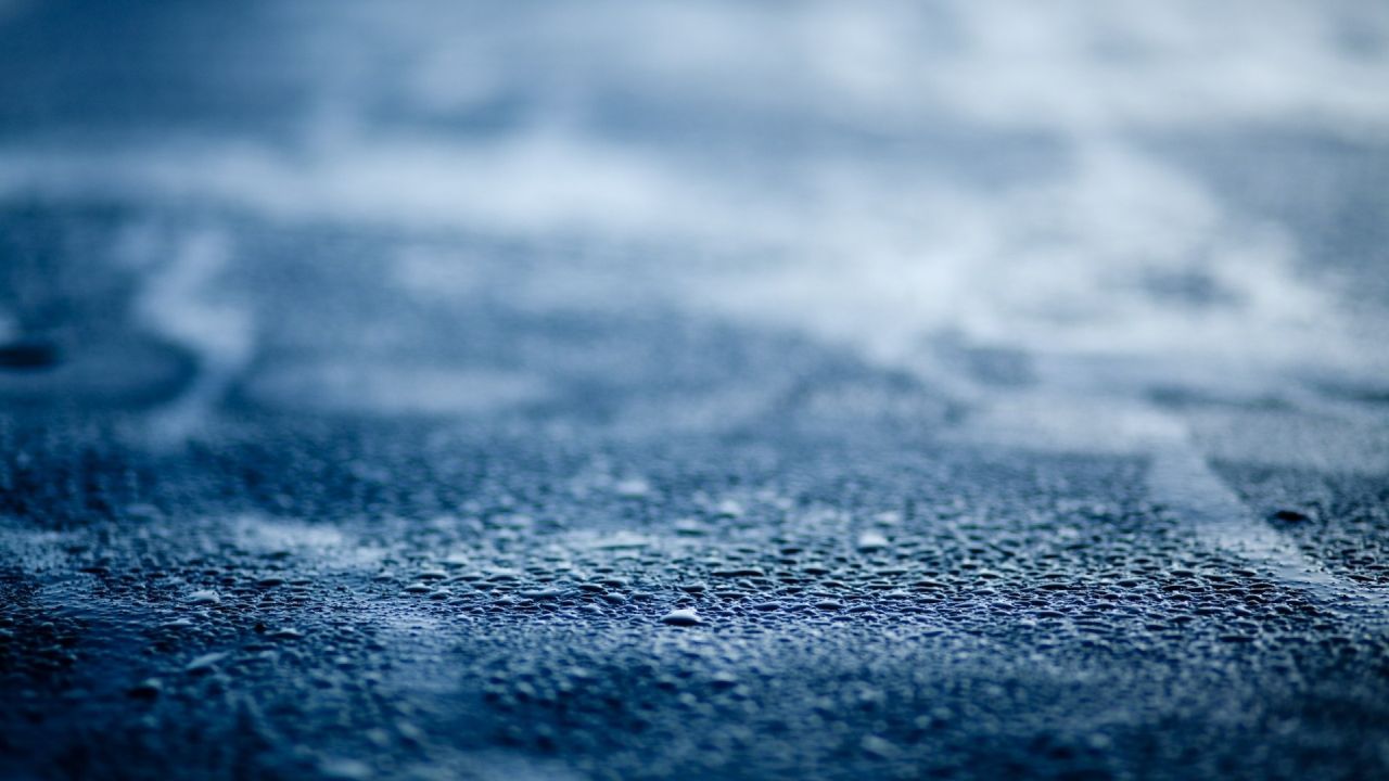 Water droplets on a blue surface close up