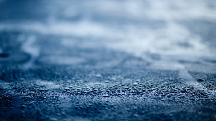 Close-up of water droplets on a blue surface
