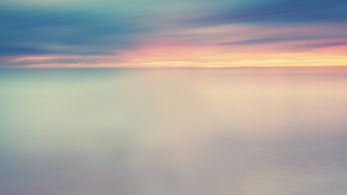 Calm sea and sky with a horizon at sunset, soft colors