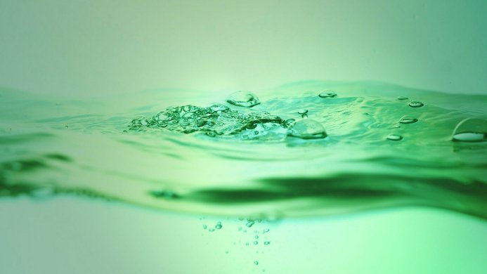 Green water with bubbles close-up