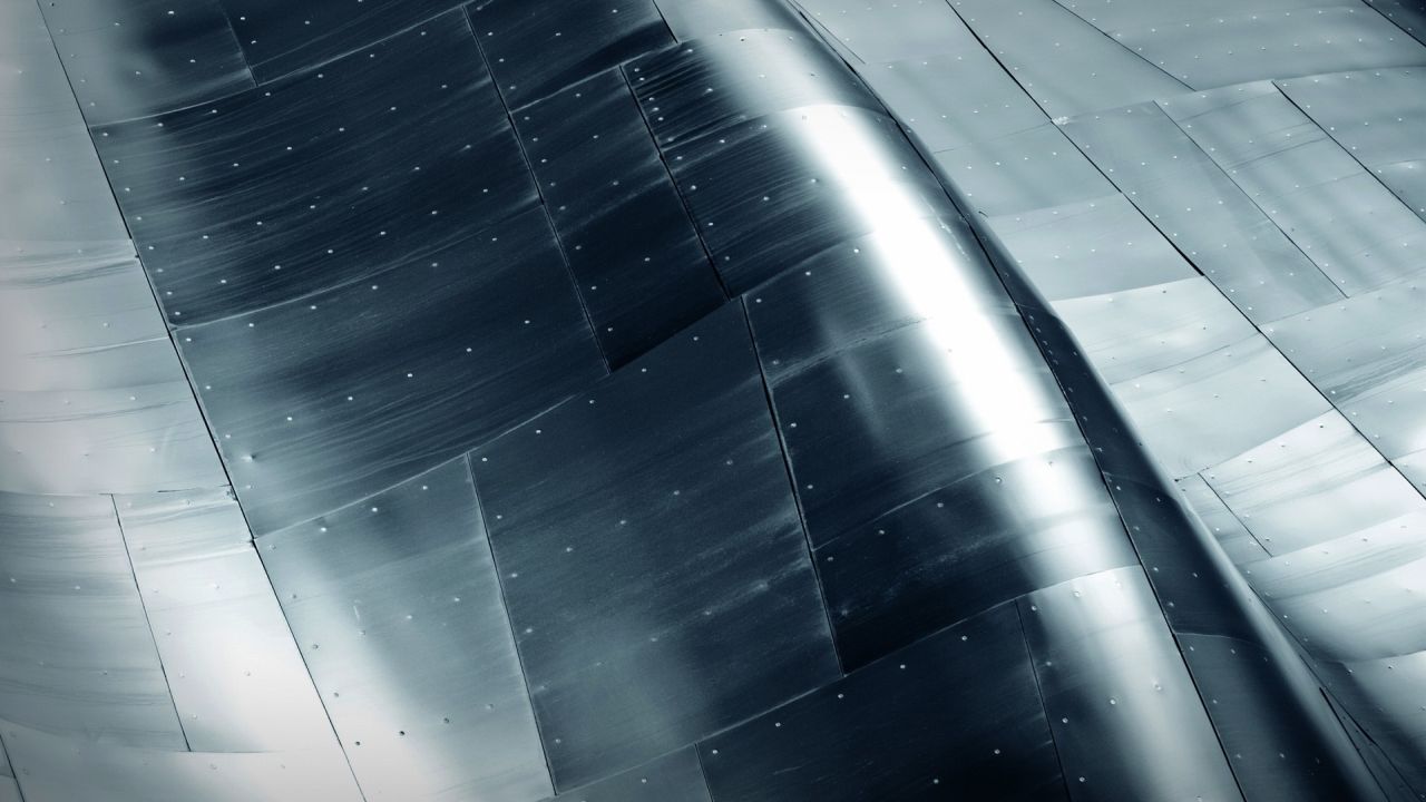 Abstract metal surface with curves and rivets