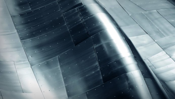 Metal panels with rivets in an abstract pattern of gray, silver, and blue