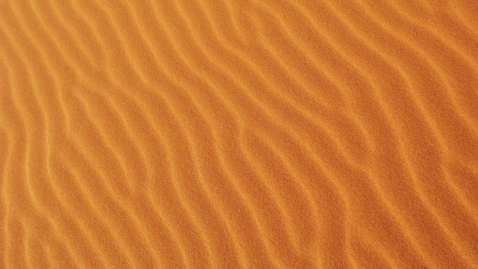 Orange sand dunes with rippled texture