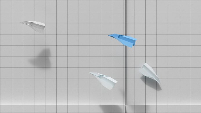 Four paper airplanes, three white and one blue, on a gridded background