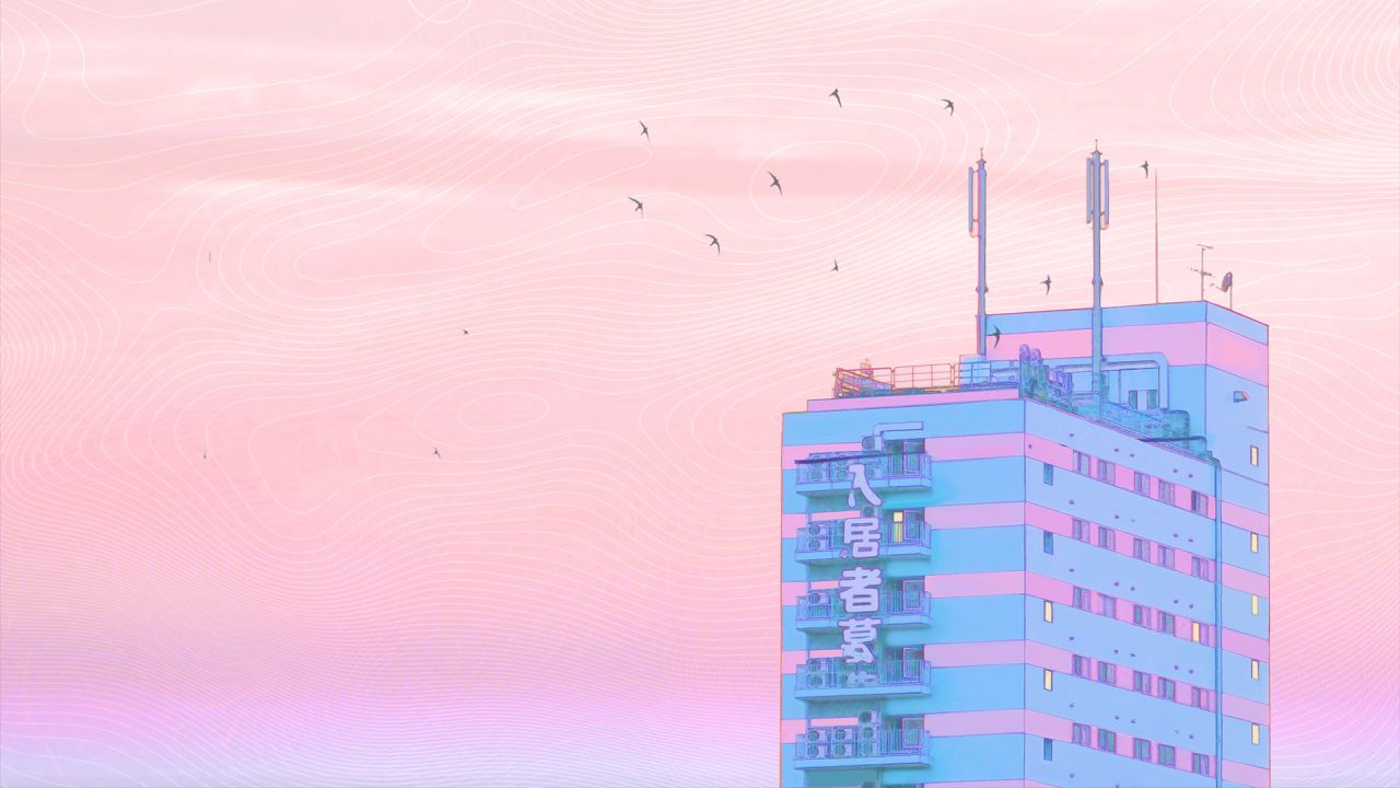 Pastel building in city with birds flying in sky