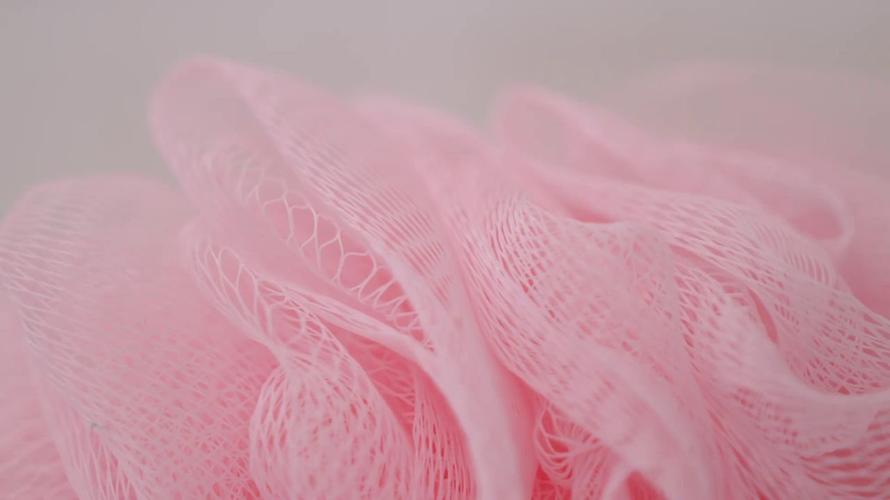 Close up of a pink bath sponge