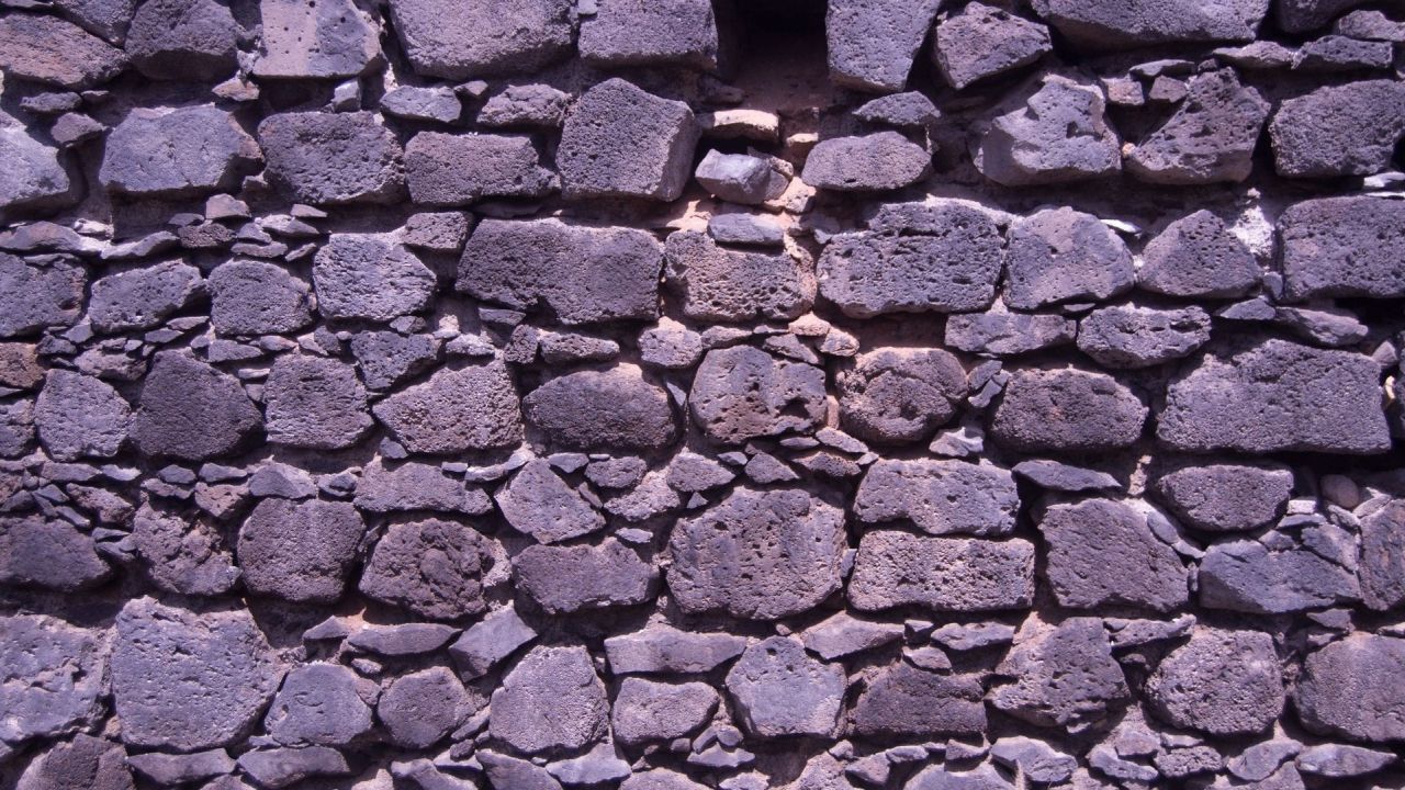 Close up view of a rough stone wall texture