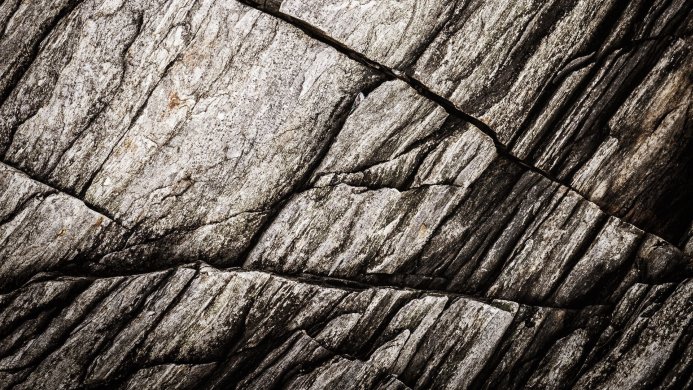 Close-up of a rock face with visible cracks and textured surface