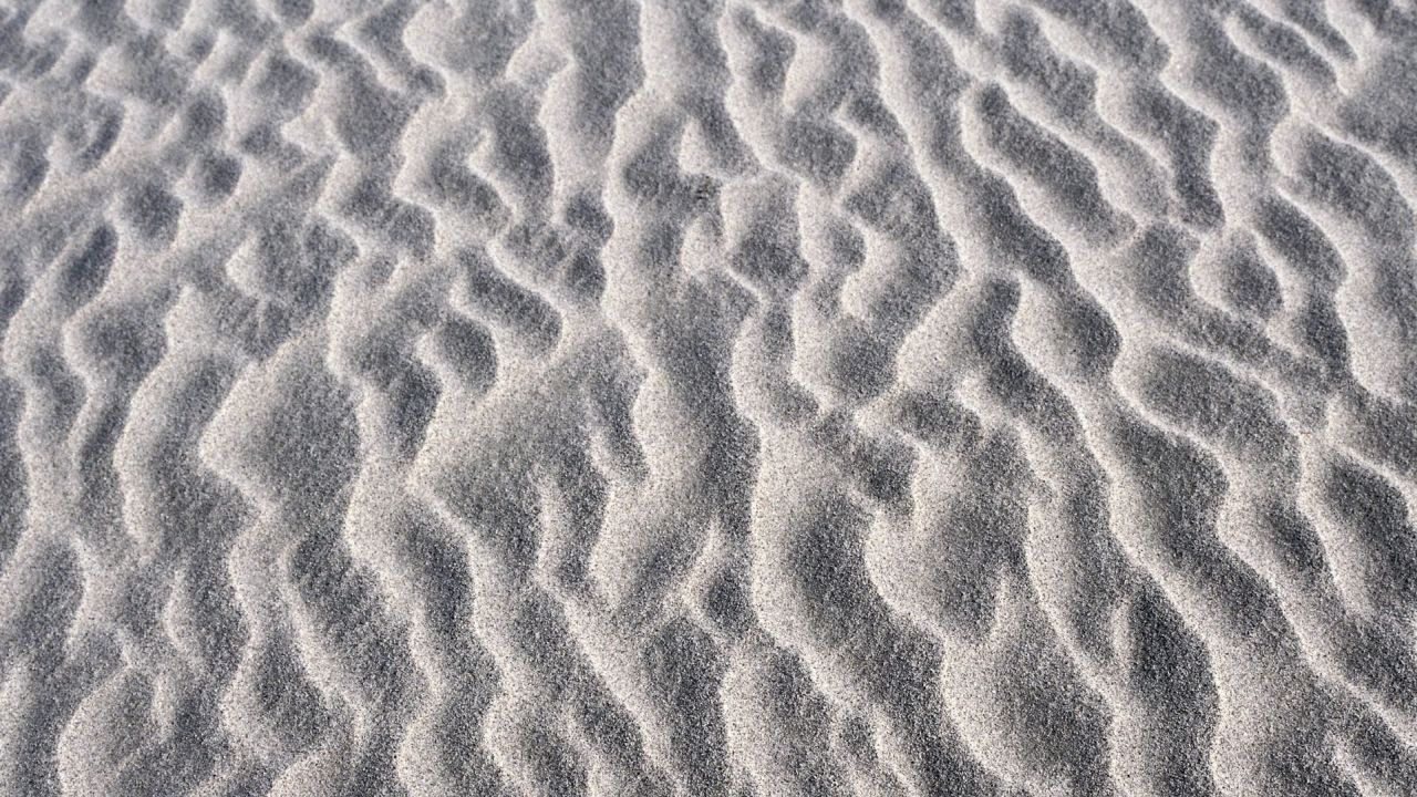Sand ripples pattern texture close up