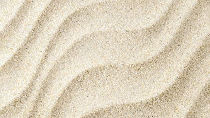 Close-up of sand with wave-like patterns