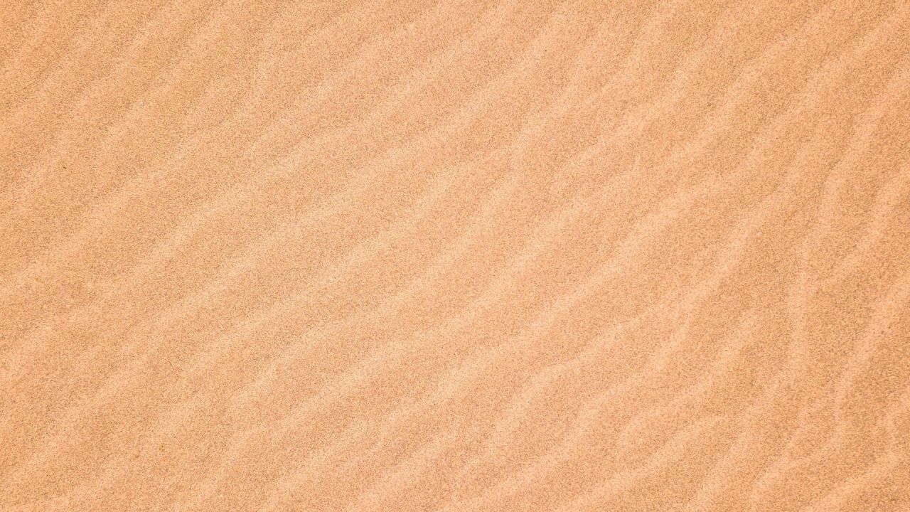 Sandy surface texture background with ripples