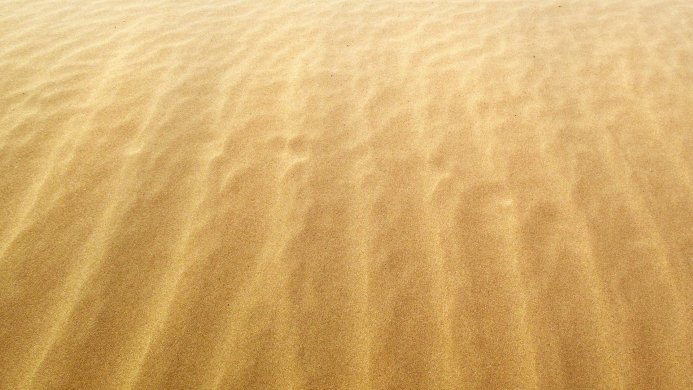 Texture of sand with wave-like patterns