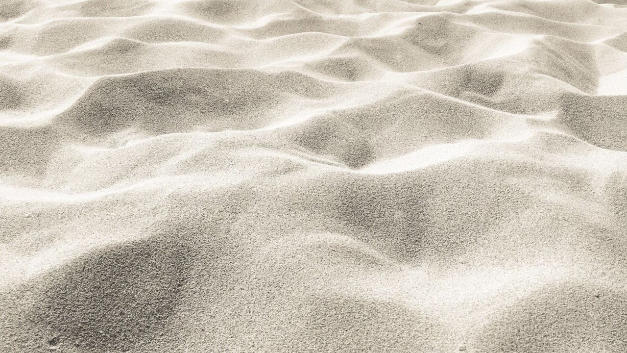 Sand texture close up with ripples and shadow