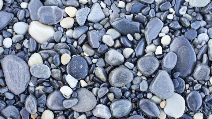 Collection of smooth, rounded stones in shades of gray, blue, and white