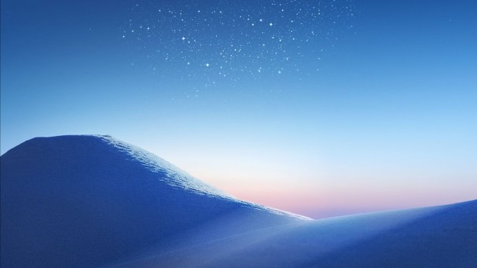 Snowy dunes under a starry blue sky with a pastel-colored horizon