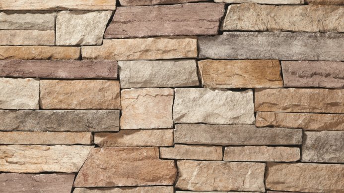 Close-up of a stone wall with various sized and colored stones