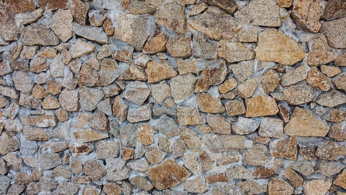 Stone wall background with brown and gray stones