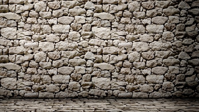 A rough stone wall with a matching stone floor