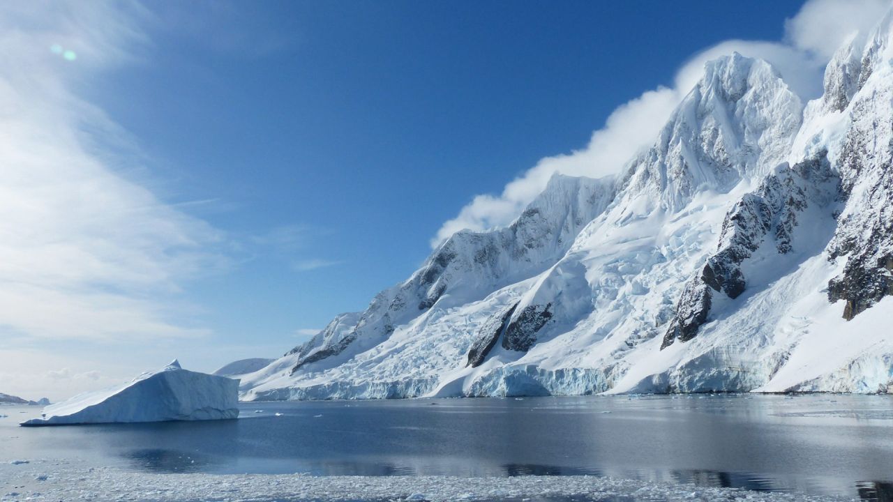 Iceberg against a mountain backdrop