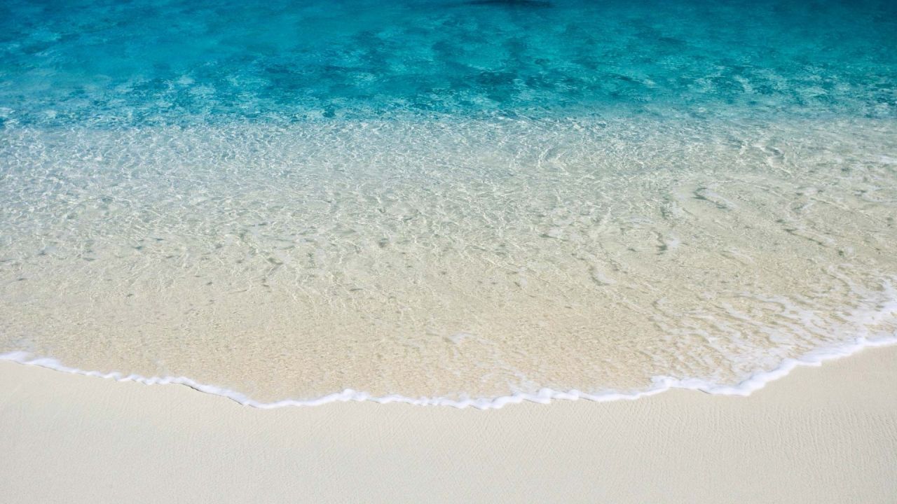 Crystal clear sea water and sand beach