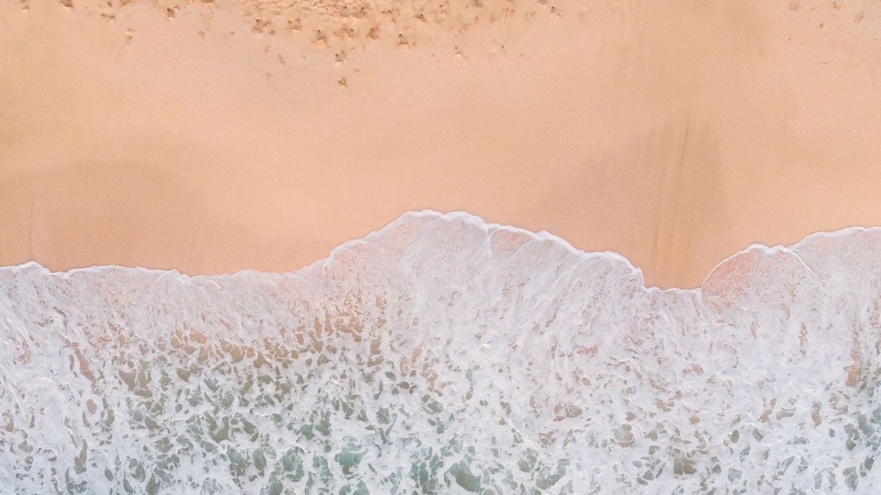 Aerial view of waves on a sandy beach