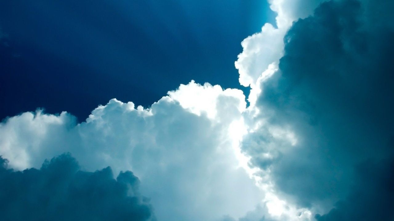 White clouds against a dark blue sky