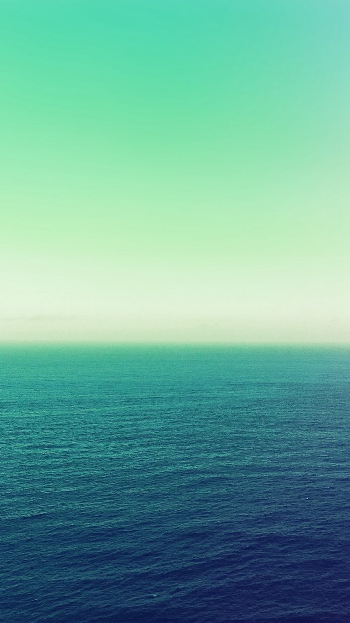 Calm sea with a gradient sky in shades of blue and green