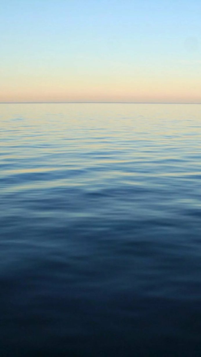 Calm sea with gradient sky at dawn