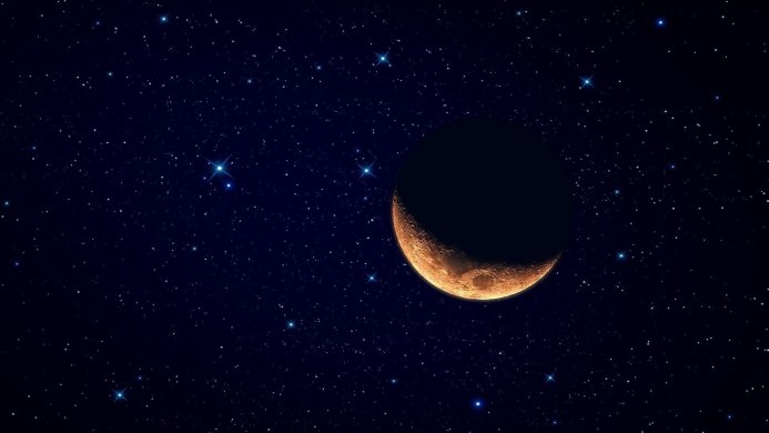 Crescent moon shining in a dark blue starry sky