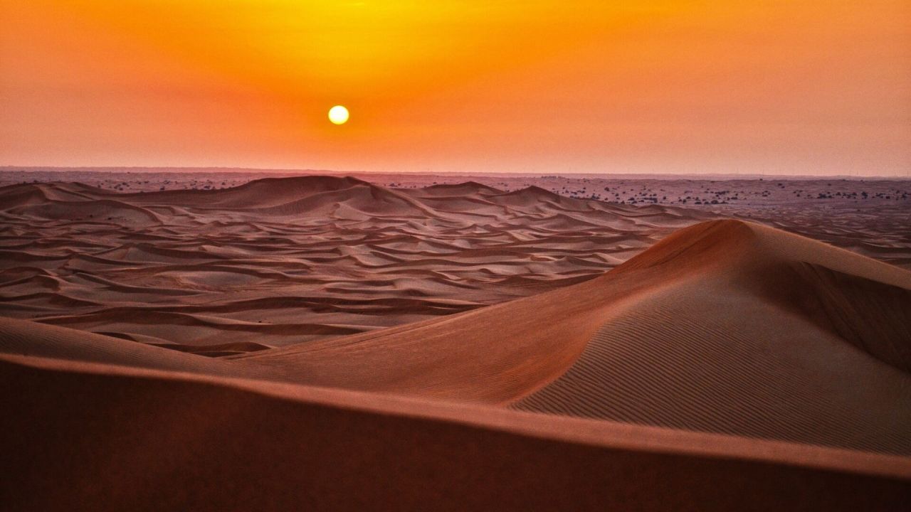 Sunset over sand dunes in desert