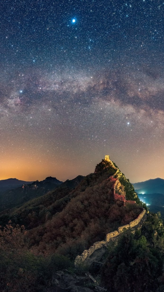 Great Wall of China at night under a sky full of stars