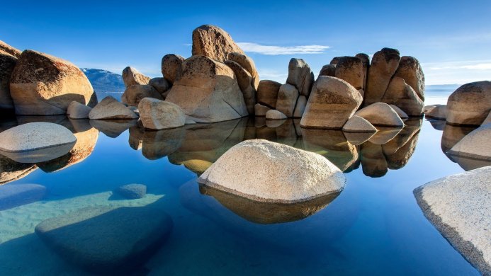 Rocks in Lake Tahoe with clear blue water and sky