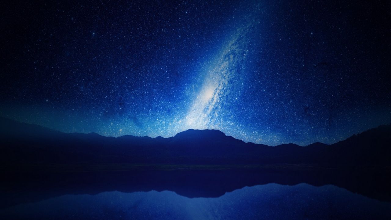 Milky Way over mountains reflected in lake