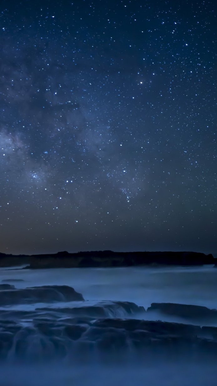 The Milky Way over rocks and water