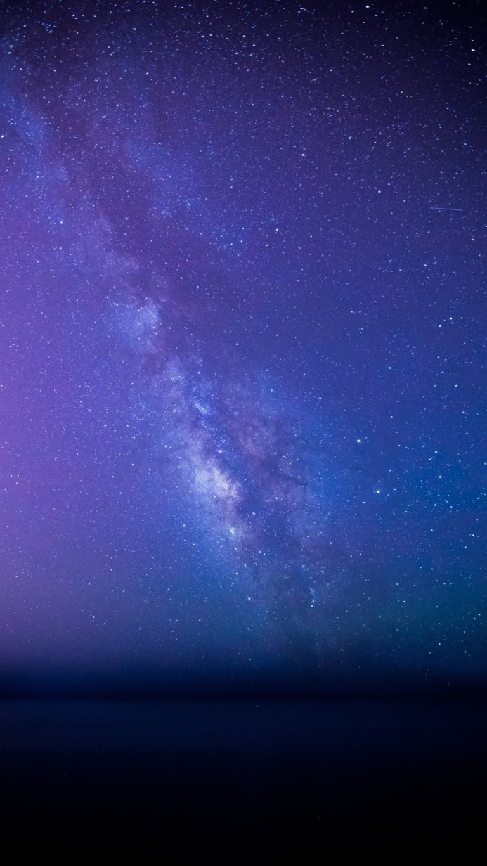 Milky Way galaxy with stars in the night sky, blue and purple tones