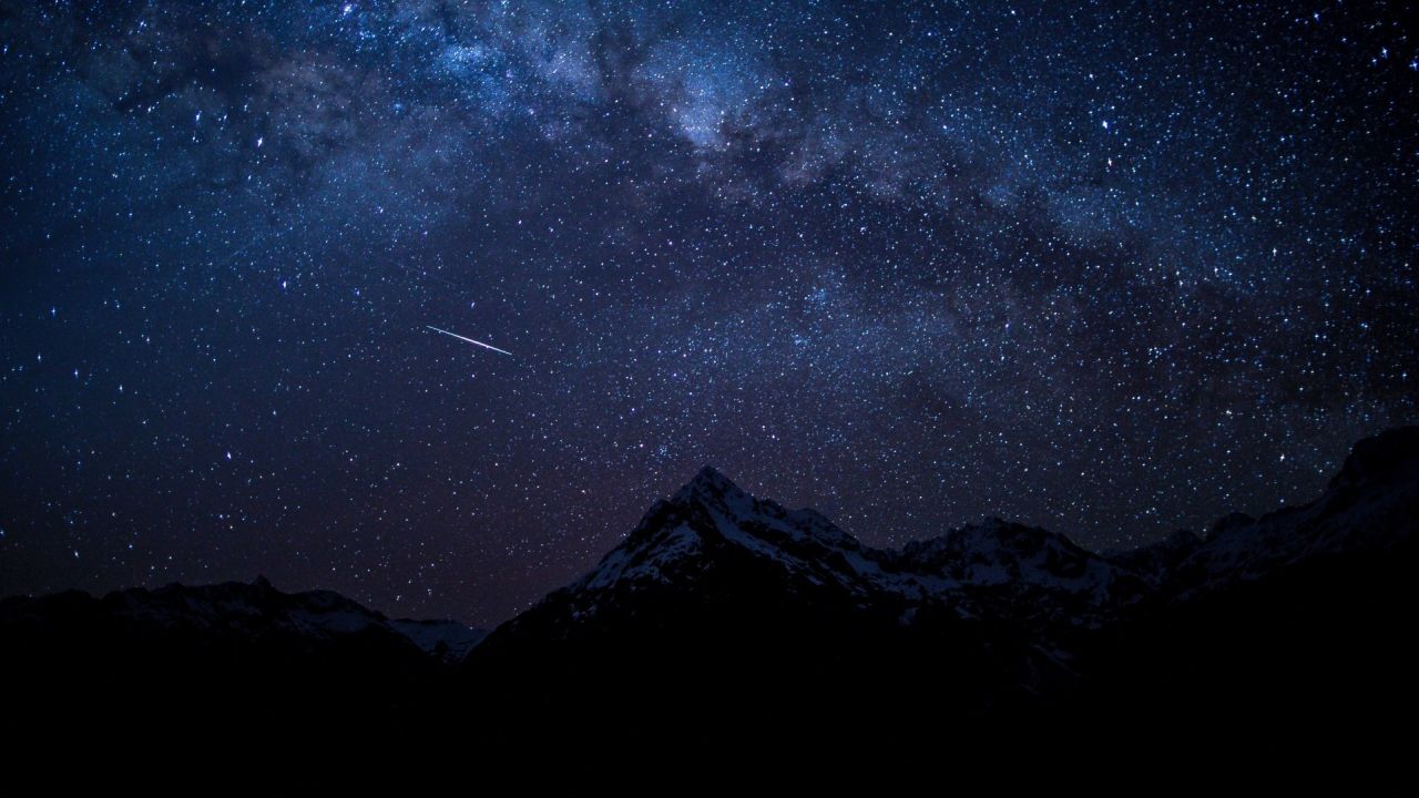 Night sky with milky way over mountains