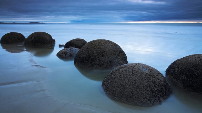 Moeraki Boulders on Koekohe Beach, New Zealand, at dusk