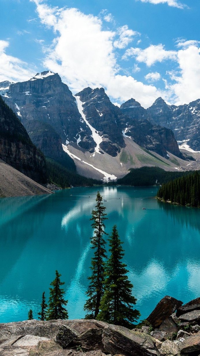 Moraine Lake with mountains and trees on a sunny day